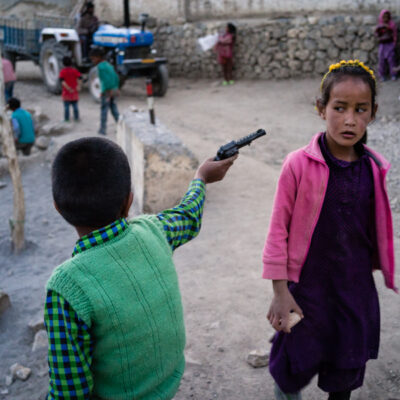 The children are playing waiting for the evening return of the cattle.